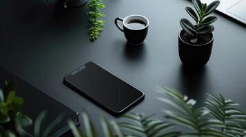 Top view of modern workspace with laptop, smartphone and plant on dark table photo