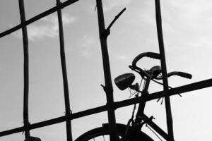 Silhouette photo of a bicycle in a rice field taken in Malang, Indonesia on May 20 2021