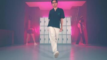 Man performing dynamic dance move in dimly lit room video