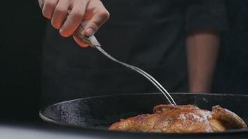 the chef flips a whole grilled chicken with a large fork video