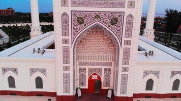 A drone flies over a beautiful mosque in the early hours of the morning. On the background of dawn in a cloudy sky. video
