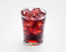 a glass of red drink with ice cubes photo