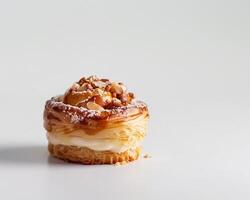 A Pastry with Nuts and Cream on Top photo