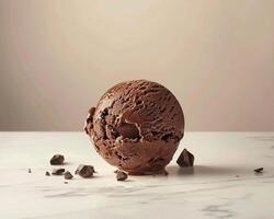Chocolate Ice Cream Ball on a Marble Surface photo