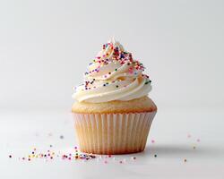 A Cupcake with Pink Frosting and Sprinkles photo