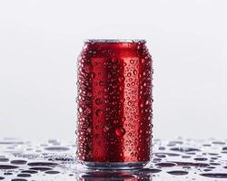 A Red Can of Soda on a Table with Water Droplets photo