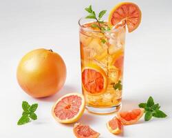 a glass of orange juice with slices of grapefruit photo