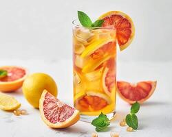 a glass of orange juice with slices of grapefruit photo