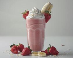a strawberry milkshake with whipped cream and bananas photo