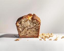 a loaf of bread with a piece missing on a white surface photo