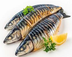 Three mackerel fish with lemon slices on a white surface photo