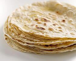 a stack of tortillas on a white surface photo