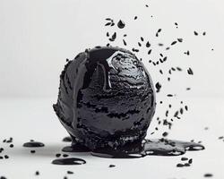 a black ice cream with a splash of black liquid photo