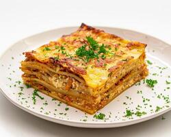 A plate of lasagna with parsley on top photo