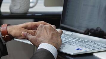 Hands of an businessman in expensive clothes work at computers in the office. video