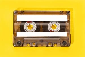 Old tape cassette with blank labels isolated on yellow background, Template mock up photo