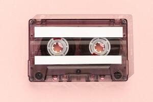 Old tape cassette with blank labels isolated on pink background, Template mock up photo