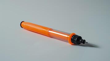 Precision Orange Handheld Solder Sucker with Black Nozzle on a White Background photo