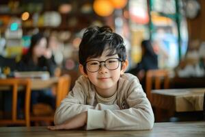 asian boy schoolboy in glasses sitting at table, school, studying, vision problem, vision correction, optics, ophthalmology photo