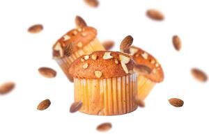 Muffins and almonds flying on a white background. photo