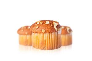 Close-up of delicious almond topped muffin with reflection on white background photo
