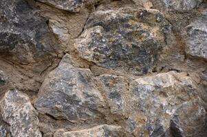 Texture of a stone wall. Old castle stone wall texture background. photo