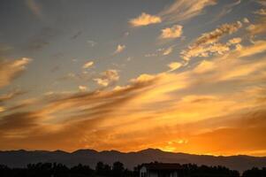 Colourful sunset sky. Full frame view of wispy colourful clouds up in the sky during sunrise or sunset hour photo