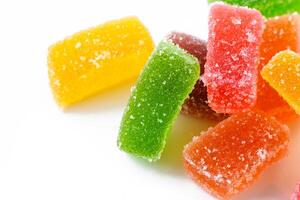 Multi-layered multicolored jelly marmalade of square shape. White background. Close-up 1 photo