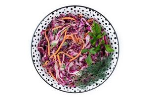 Fresh coleslaw salad with red and white cabbage and carrots in bowl on white background. Top view. Copy space. photo