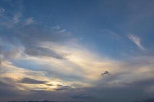 A view of pink clouds against a blue sky at sunset - stock photo 1