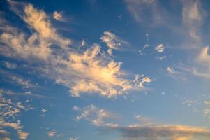 The gathering clouds during sunset create abstract painting patterns in the western sky. photo