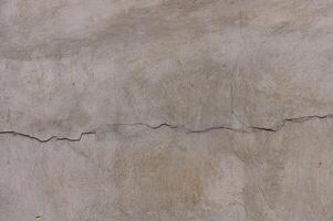 gray concrete wall, floor with pattern and cracks, texture background photo