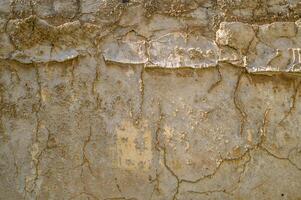 yellow texture of cracked concrete wall. Abstract background of a crack in a concrete wall. photo