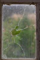 Window with broken glass in old building Wooden window frame with partially broken glass in old abandoned brick building 1 photo