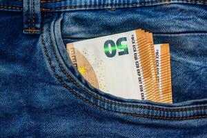 Concept of financial problems, last money. 50 euro banknote in jeans pocket. photo