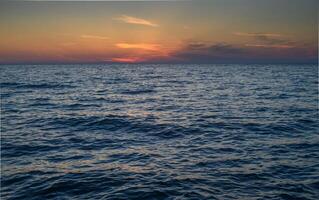 sunset and waves on the Mediterranean coast on the island of Cyprus photo