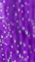Purple flower petal becoming blurred. Stock footage. Extreme close up of a lilac soft beautiful flower petal covered by tiny air bubbles in transparent water. video