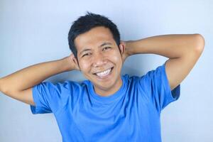 Smiling facial expression young asian man happy looking at camera, isolated on white background photo