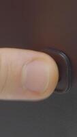 Close-up of pressing monitor start button. Action. Button for starting computer or electronic device. Finger presses computer power button video