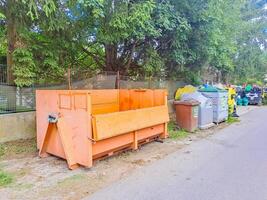 Dumpsters being full with garbage. Trash can overflowing litter pollution photo