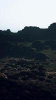 A view of a rocky mountain with a sky in the background video