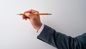 Close-up of a hand holding a pen, ready to write on something out of frame photo
