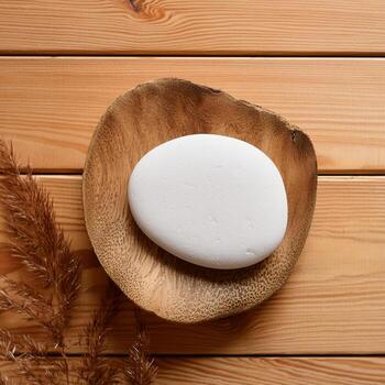 background for product display with a white stone, top view light brown wooden table surface photo