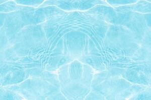 Blue water with ripples on the surface. Defocus blurred transparent blue colored clear calm water surface texture with splashes and bubbles. Water waves with shining pattern texture background. photo