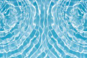 Blue water with ripples on the surface. Defocus blurred transparent blue colored clear calm water surface texture with splashes and bubbles. Water waves with shining pattern texture background. photo