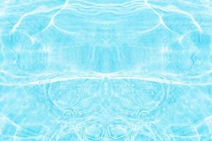 Blue water with ripples on the surface. Defocus blurred transparent blue colored clear calm water surface texture with splashes and bubbles. Water waves with shining pattern texture background. photo