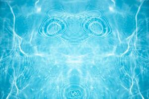 Blue water with ripples on the surface. Defocus blurred transparent blue colored clear calm water surface texture with splashes and bubbles. Water waves with shining pattern texture background. photo
