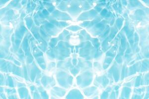 Bluewater waves on the surface ripples blurred. Defocus blurred transparent blue colored clear calm water surface texture with splash and bubbles. Water waves with shining pattern texture background. photo
