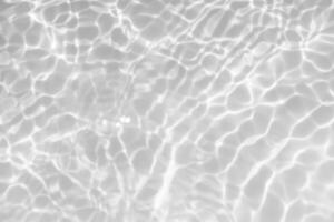 Blue water with ripples on the surface. Defocus blurred transparent blue colored clear calm water surface texture with splashes and bubbles. Water waves with shining pattern texture background. photo
