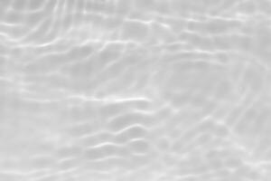 Bluewater waves on the surface ripples blurred. Defocus blurred transparent blue colored clear calm water surface texture with splash and bubbles. Water waves with shining pattern texture background. photo